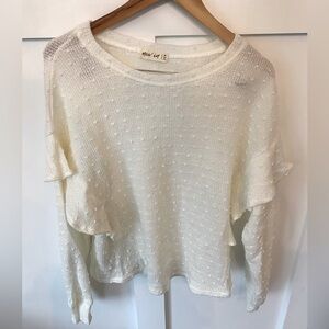 Oversized white sweater with ruffle detail